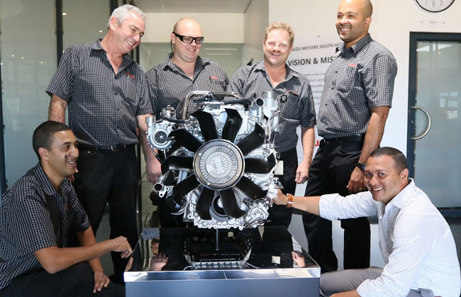 SHINING EXAMPLE: Customising the engine on display in the Isuzu Motors SA foyer in Struandale, Port Elizabeth, united new staff members who worked on it - from left are Moegamat Ally (sitting), John McLachlan, Le Clue Mostert, Francois Schellingerhout, Jermaine Fortune and Jessel Vencencie. - Image: Isuzu SA / Motorpress